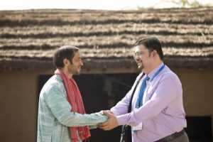 Rural farmer greeting real estate agent at village